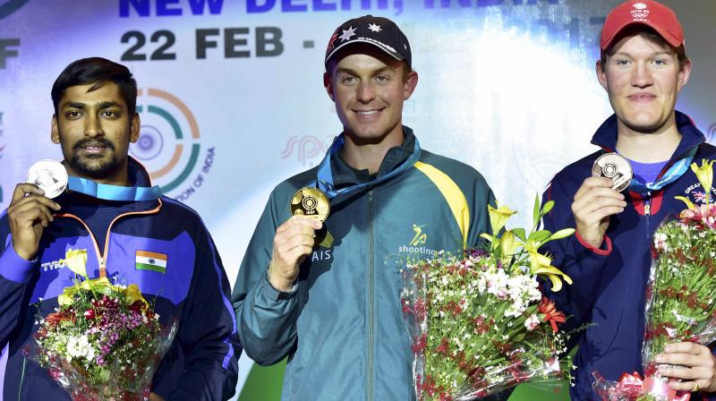 Gold medal winner Australias James Willett (C) with silver medalist Indias Ankur Mittal (L) and James Deadman of Britain after mens double trap final event of the ISSF World Cup in New Delhi on Monday. (Photo: AP)