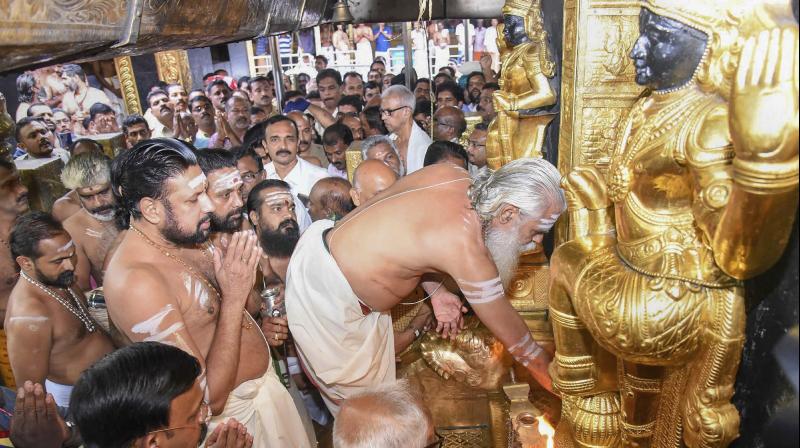 Melsanthi Unnikrishnan Nampoothiri opens the Sabarimala temple for the five-day monthly pooja in the Malayalam month of Thulam, Sabarimala on Wednesday. (Photo: PTI)