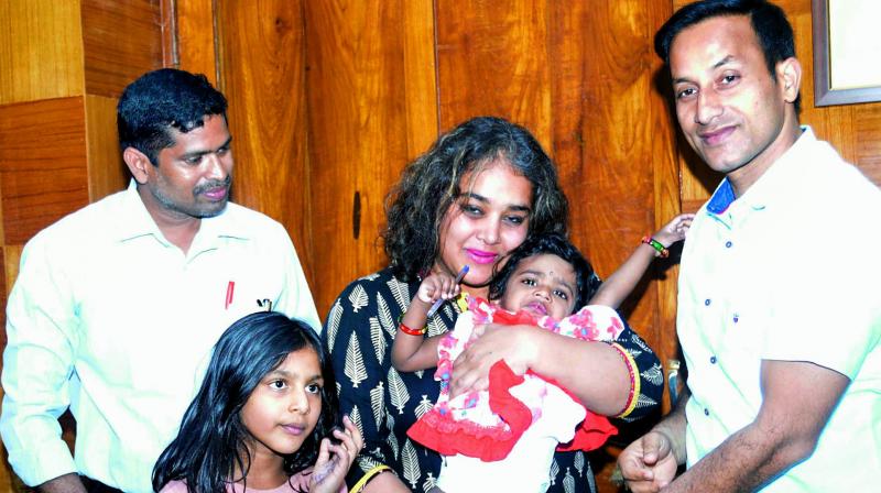 District collector Pravin Kumar hands over baby Sarayu for adoption to Vennisa Christina Sathur from Spain at his office in Vizag on Tuesday. (Photo: DC)