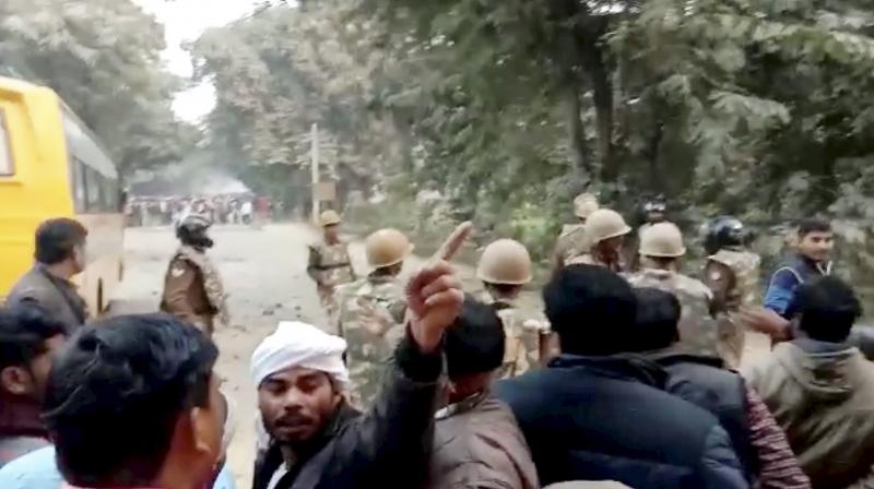 Uttar Pradesh police personnel tackle protestors following Prime Minister Narendra Modis rally in Ghazipur on Saturday. (Photo: PTI)