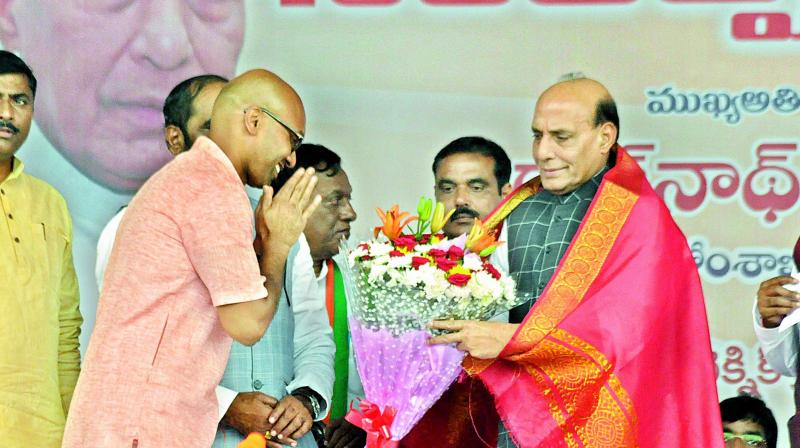 D. Arvind, son of TRS MP D. Srinivas, felicitates Union home minister Rajnath Singh at Nizamabad. Mr Arvind joined the BJP at the event. 	(Photo: DC)