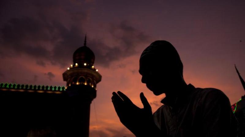 A man offer prayers before breaking his fast. (Photo: AP)
