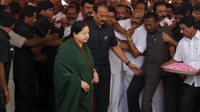 Late Tamil Nadu Chief Minister Jayalalithaa arrives to offer a floral garland to a portrait of party founder M.G.Ramamchadran in Chennai. (Photo: PTI/File)