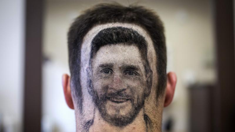 A hairdresser is clipping portraits of stars Lionel Messi or Cristiano Ronaldo onto the back of heads in soccer-made Serbia. (Photo: AFP)