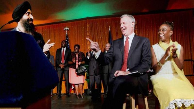 New York City mayor Bill de Blasio and his wife Chirlane McCray enjoy a light moment as actor and designer Waris Ahluwalia (left) speaks on the occasion of Diwali celebration at the mayors official residence in New York on Wednesday. (Photo: PTI)