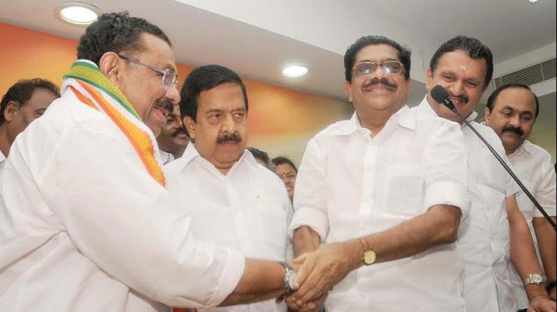 Former KPCC president V. M. Sudheeran congratulates his successor M. M. Hassan after the latter took over as the temporary party chief at Indira Bhavan in Thiruvananthapuram on Sunday. Also seen are Opposition leader Ramesh Chennithala, former KPCC president K. Muraleedharan, and KPCC vice-president V. D. Satheesan. (Photo: A.V. MUZAFAR)