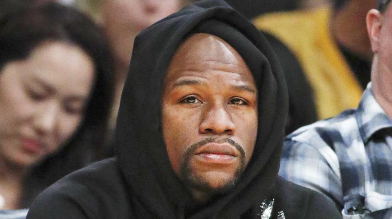 Boxer Floyd Mayweather Jr. attends an NBA basketball game between the Los Angeles Lakers and the San Antonio Spurs in Los Angeles. (Photo: AP)