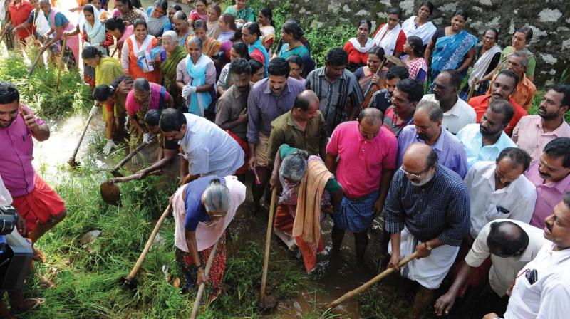 Finance Minister Thomas Isaac among others engaged in cleaning Killiyaar at Moozhi  on Saturday.