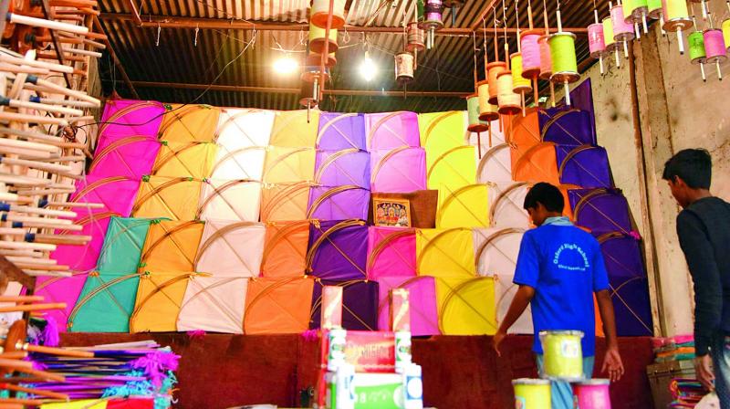 Top: People purchase kites  at Dhoolpet ahead of Sankranti on Wednesday. Below: Kites and Manjas on display at a kite shop on Wednesday. (Photo: DC)