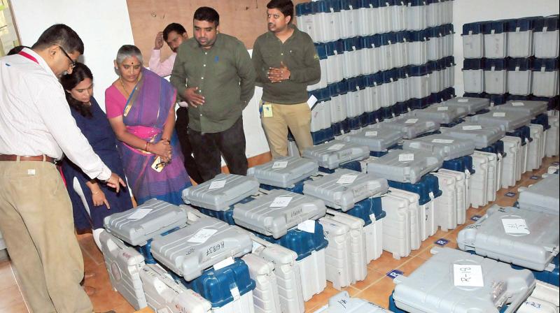 Poll officials collect their EVMs on the eve of voting in the Jayanagar constituency, in Bengaluru on Sunday.  (Photo:KPN)