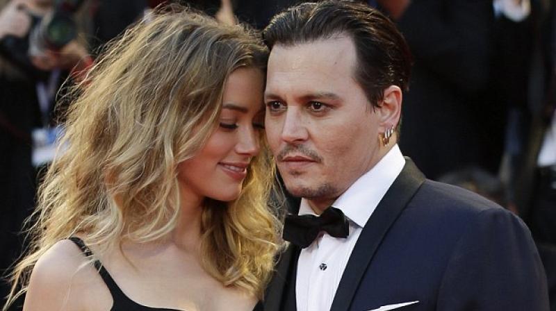 Amber Heard and Johnny Depp (Photo credit: AP).