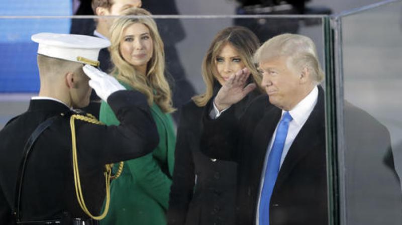President-elect Donald Trump salutes as he arrives with his wife Melania Trump and daughter Ivanka Trump at a pre-Inaugural \Make America Great Again! Welcome Celebration\ at the Lincoln Memorial in Washington. (Photo: AP)