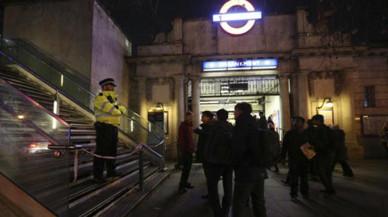 A police officer outside Embankment tube station in central London stops pedestrians from using the Hungerford Bridge, as a suspected unexploded World War II bomb has been found in the River Thames, forcing the closure of Waterloo and Westminster bridges. (Photo: AP)