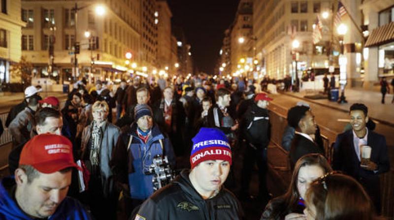 Spectators wait in line to pass through security checkpoints of President-elect Donald Trumps inauguration. (Photo: AP)