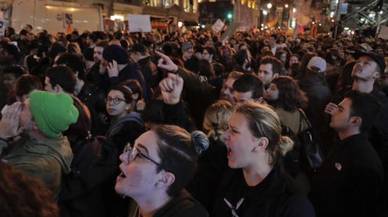 Protesters chant slogans on Fifth Avenue outside Trump Tower in New York. (Photo: AP)