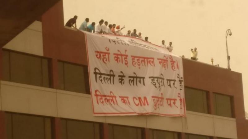 BJP leaders reportedly suspended a large banner from the roof of the Delhi Secretariat building saying: Delhi Secretariat, theres no strike here. People of Delhi are on duty. The Chief Minister of Delhi is on leave. (Photo: Twitter@ArvindKejriwal)