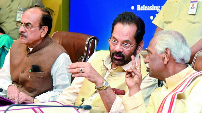 Mukhtar Abbas Naqvi, Union minister of state for minority affairs and parliamentary affairs converses with Bandaru Dattatreya, union minister of state for labour and employment at the inauguration of the Annual Conference of SCAs (State Channelising Agencies) of National Minorities Development and Finance Corporation (NMDFC) held at MCR HRD in Hyderabad. Also seen is Mahamood Ali, Telangana deputy CM.