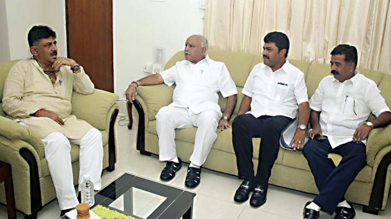 BJP state president B. S. Yeddyurappa at a meeting with Water Resource Minister, D.K. Shivakumar at his residence in Bengaluru on Wednesday . Also present are MLA Hartalu Halappa and MP B.Y. Raghavendra 	DC