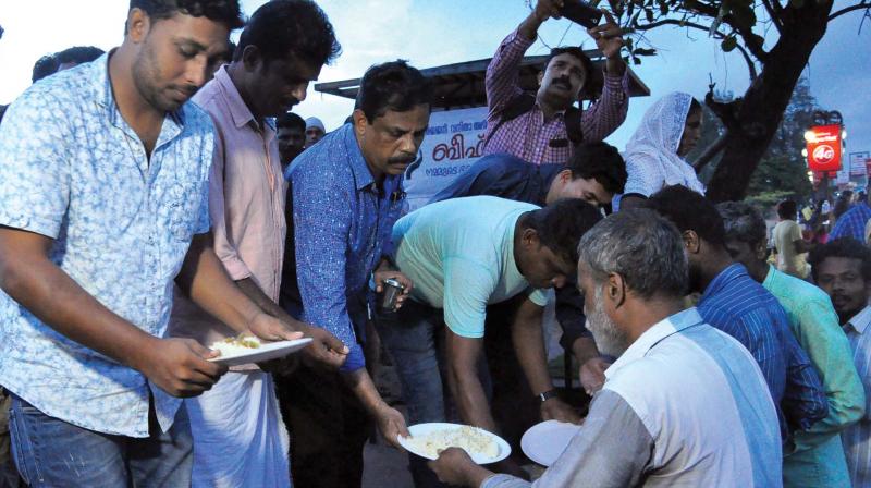 People participate in the beef fest organised by Punarjani on the Kozhikode beach on Saturday. Advocate Zeenath (in white scarf), one of the  organisers, is partly seen. (Photo: DC)