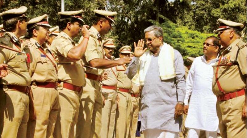 Chief Minister Siddaramaiah greets police officers in this file photo.