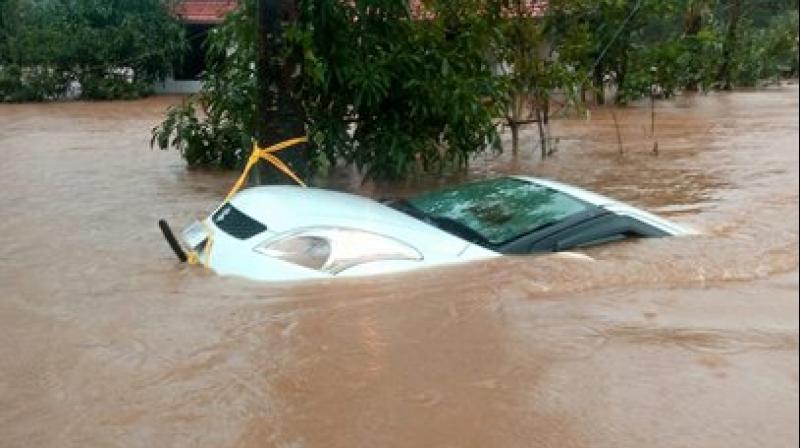 A car is seen submerged in flood water after heavy rainfall, at Vythiri in Wayanad district of Kerala. (Photo: PTI)