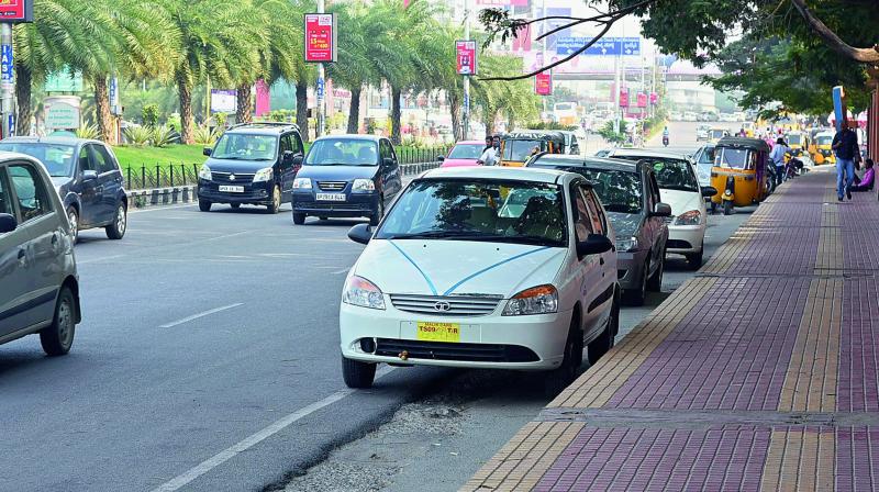 Parked cabs occupy crucial space on the roads in the IT corridor, leaving little space for the heavy traffic that the area sees during peak hours.  (Photo: DECCAN CHRONICLE)