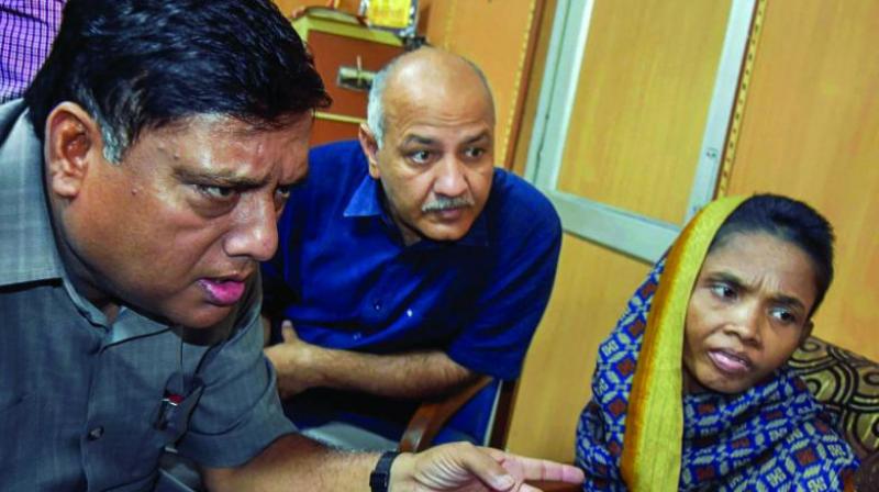 Delhi Deputy Chief Minister Manish Sisodia, along with an official, meets the mother of three girls who allegedly died of malnutrition at Mandawali in New Delhi on Thursday. (Photo: PTI)
