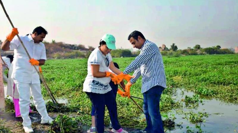 Volunteers take part in a cleaning drive at the Gangaram Lake which started on Sunday.