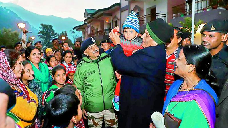 Home minister Rajnath Singh with families of ITBP troops at Matli in Uttarkashi in Uttarakhand on Sunday. 	(Photo: PTI)