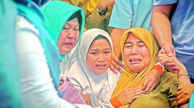Family members of Indonesian Lion Air JT-610 weep for their relations at Pangkal Pinang airport, in Bangka Belitung province on Monday. (Photo: AFP)