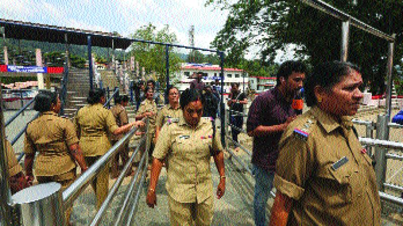 Police women, above the age of 50, who have been deployed for security return after worshipping at the Sabarimala temple, one of the worlds largest Hindu pilgrimage sites, in the southern Indian state of Kerala, Monday (Photo: AP)