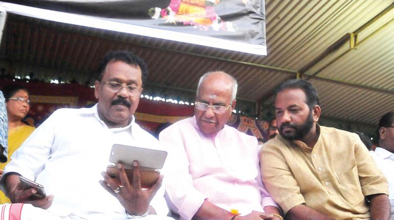 BJP state president P.S. Sreedharan Pillai, O. Rajagopal, MLA, and district president S. Suresh watch live footage of Pinarayi Vijayans speech at Kannur, during the Akhanda Nama Japa in front of Secretariat in Thiruvananthapuram on Monday.