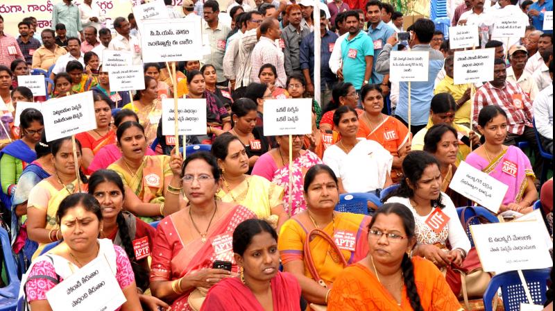 Employees take part in a protest against the Contributory Pension Scheme by the government near GVMC Gandhi statue in Visakhapatnam on Saturday. (Photo: DC)