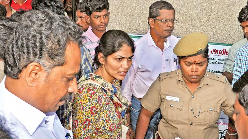 Police personnel and transport minister  M.R. Vijayabhaskar try to pacify Annapoorna who alleged harassment by police at Koyambedu on Monday (Photo: DC)