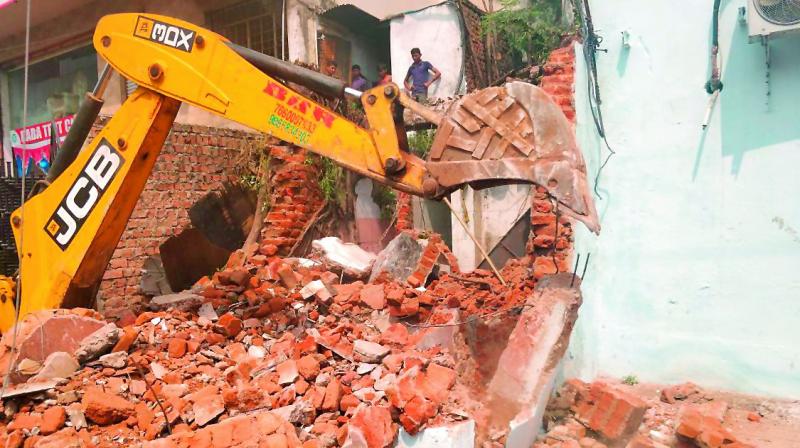 GHMC authorities, with the assistance of city police, demolished about 40 structures that had encroached upon the nala at Hashmabad in Chandrayangutta on Friday.  (Photo: DC)