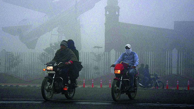 People on a road covered with a thick layer of fog in Amritsar on Monday. (Photo: PTI)