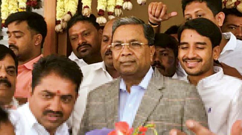 Former CM Siddaramaiah with supporters at his residence in Bengaluru on Monday before leaving for the airport.