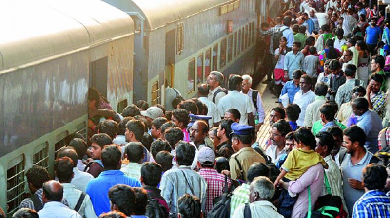 Passengers jostle in a crowd to get into a railway bogie at the Secunderabad Railway station. (Photo: DC/File)