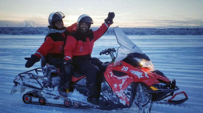 Carlton with a friend indulge in snowmobile racing on the Kemijoki