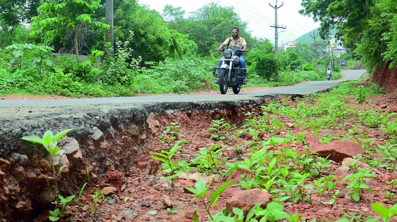 Bikers have a tough-time negotiating the incomplete road widening works in the Visakhapatnam on Saturday. (Photo: DC)