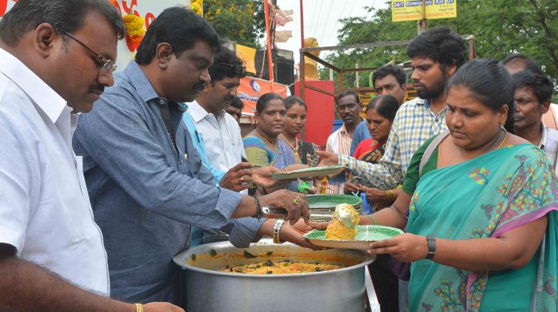 Viswa Seva Parishat sevaks serve food to attendants of patients at Vijayawada Government General Hospital.