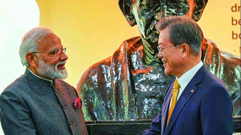 PM Narendra Modi and South Korean President Moon Jae-in after unveiling the bust of Mahatma Gandhi at the Yonsei University in Seoul on Thursday. (Photo: PTI)