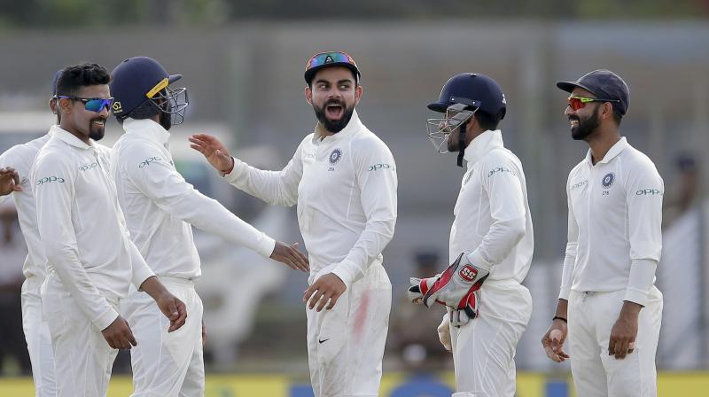 Indias cricket captain Virat Kohli, center, and Raveendra Jadejam, left, celebrate the dismissal of Sri Lankas Upul Tharanga. (Photo: AP)
