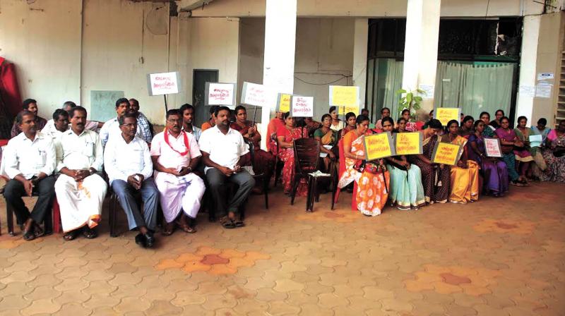 Protesting employees sitting in front of Kannur Medical College Hospital at Anjarakkandy in Kannur on Friday.  (Photo: AKHIN DEV)