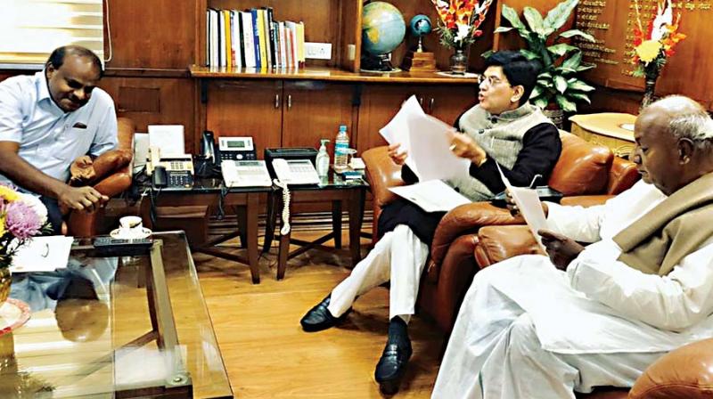 Chief Minister H.D. Kumaraswamy, former Prime Minister and JD(S) supremo H.D. Deve Gowda  at a meeting with Railways Minister Piyush Goyal in New Delhi on Thursday 	 KPN