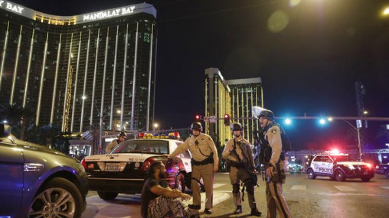 On October 1, 2017 police officers stand at the scene of a mass shooting near the Mandalay Bay resort and casino on the Las Vegas Strip, in Las Vegas. (Photo: AP/File)