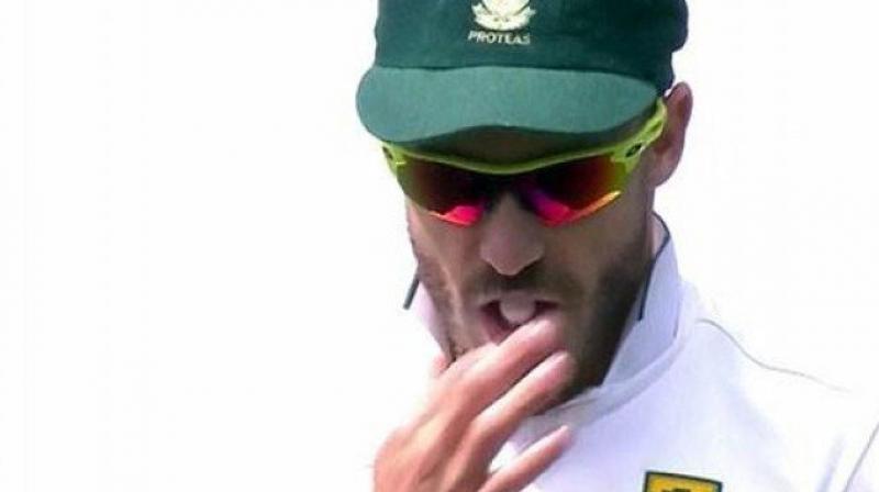 The footage shows Du Plessis with a white lolly in his mouth, licking his finger before shining the ball. (Photo: Screengrab)