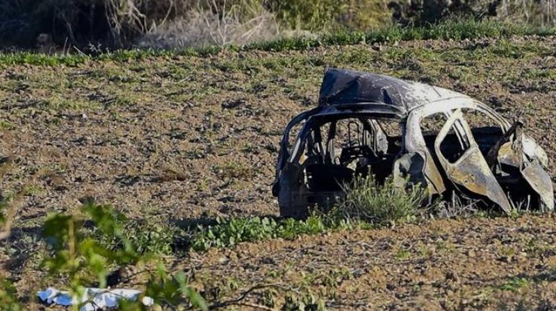 The wreckage of the car of investigative journalist Daphne Caruana Galizia lies next to a road in the town of Mosta, Malta, Monday, Oct. 16, 2017. (Photo: AP)
