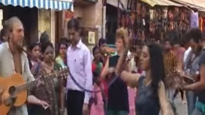 The enterprising firangs played musical instruments and even did acrobatic stunts with hoops for their street show. (Credit: YouTube)