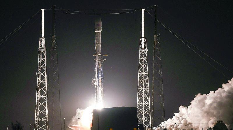 A SpaceX Falcon 9 rocket lifts off early on Tuesday, from Cape Canaveral Air Force Station, Fla. 	 	 AP
